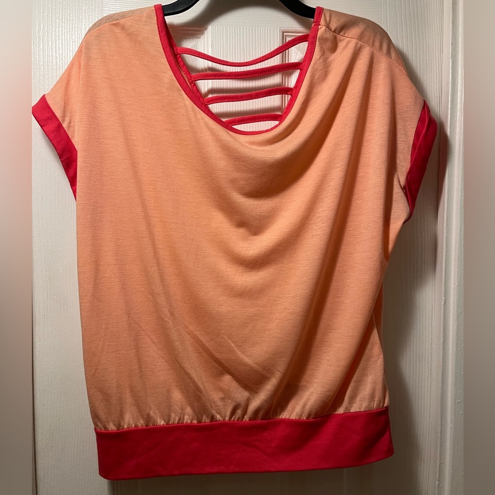 Light orange short sleeve top with dark orange trim and upper back strap detail